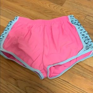 Pink athletic shorts with dogs on sides